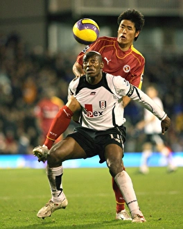 Seol Ki-Hyeon climbs all over Luis Boa Morte to get to the ball Seol Ki-Hyeon climbs all over Luis Boa Morte to get to the ball